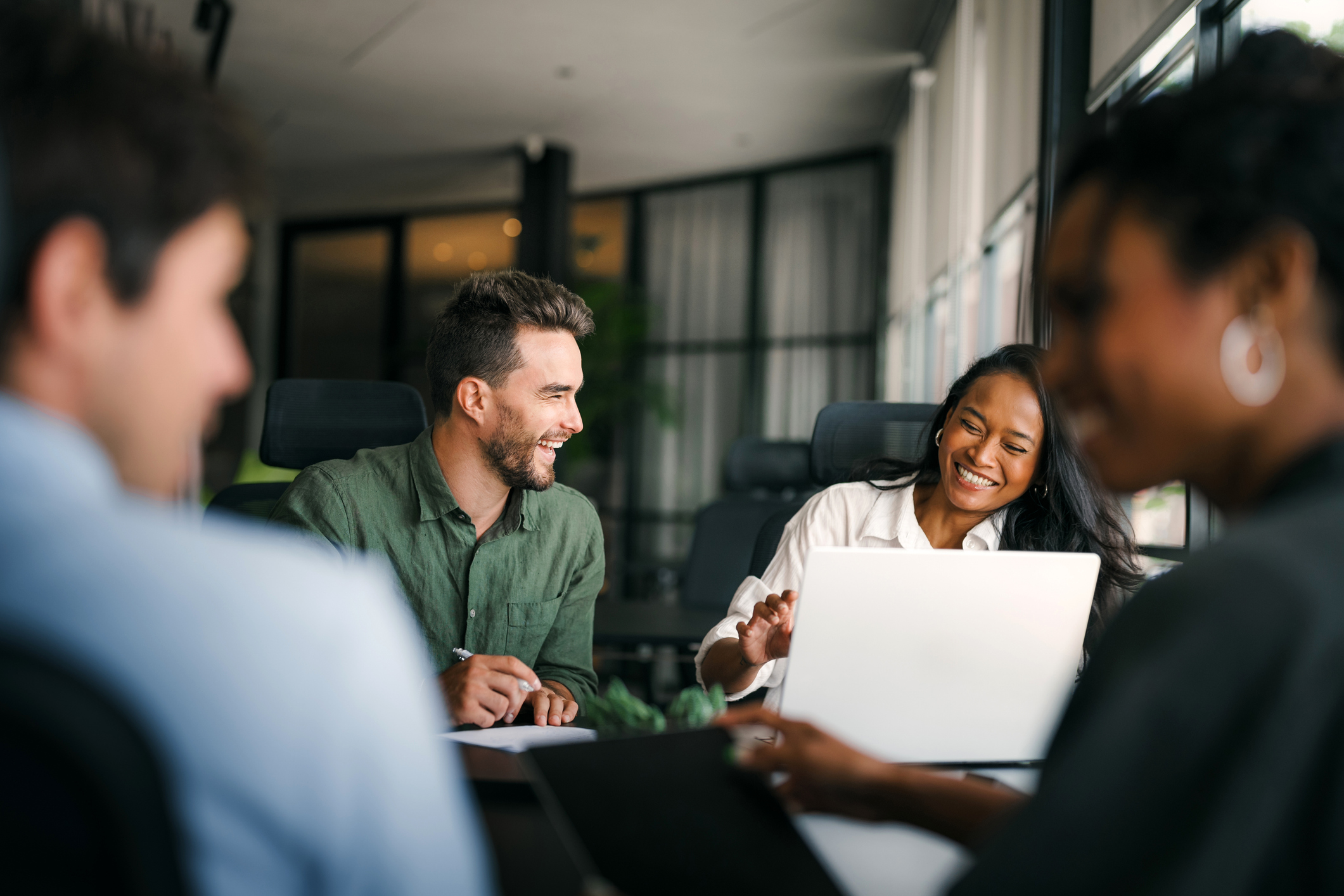 Legal professionals collaborating around a table in a modern office