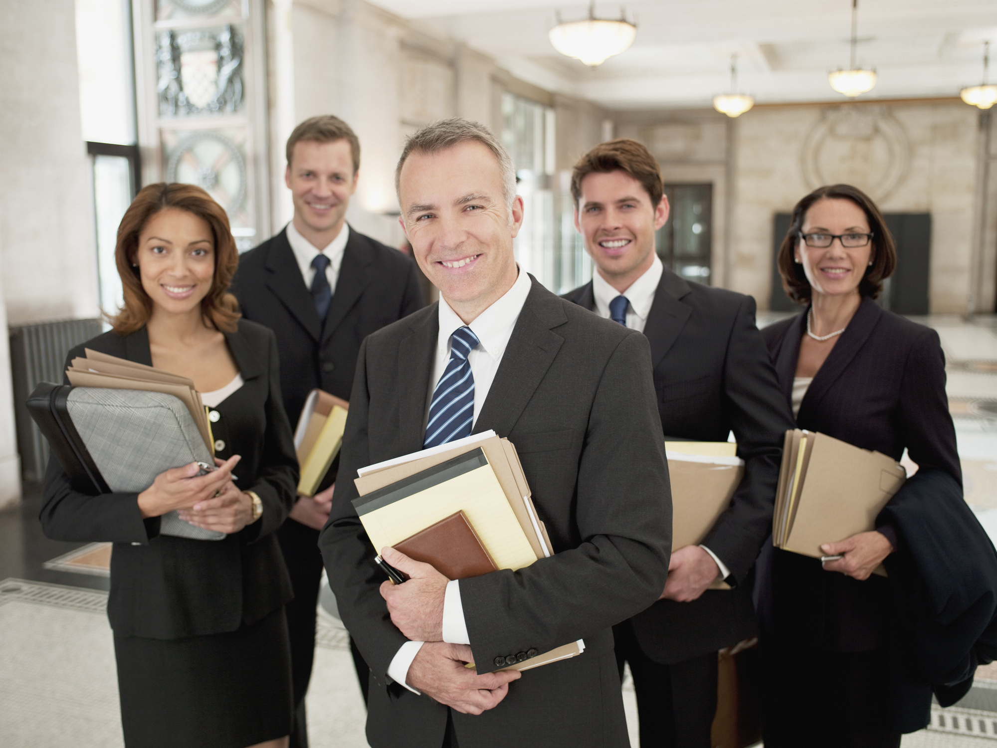 Litigation attorneys holding case files while preparing for court