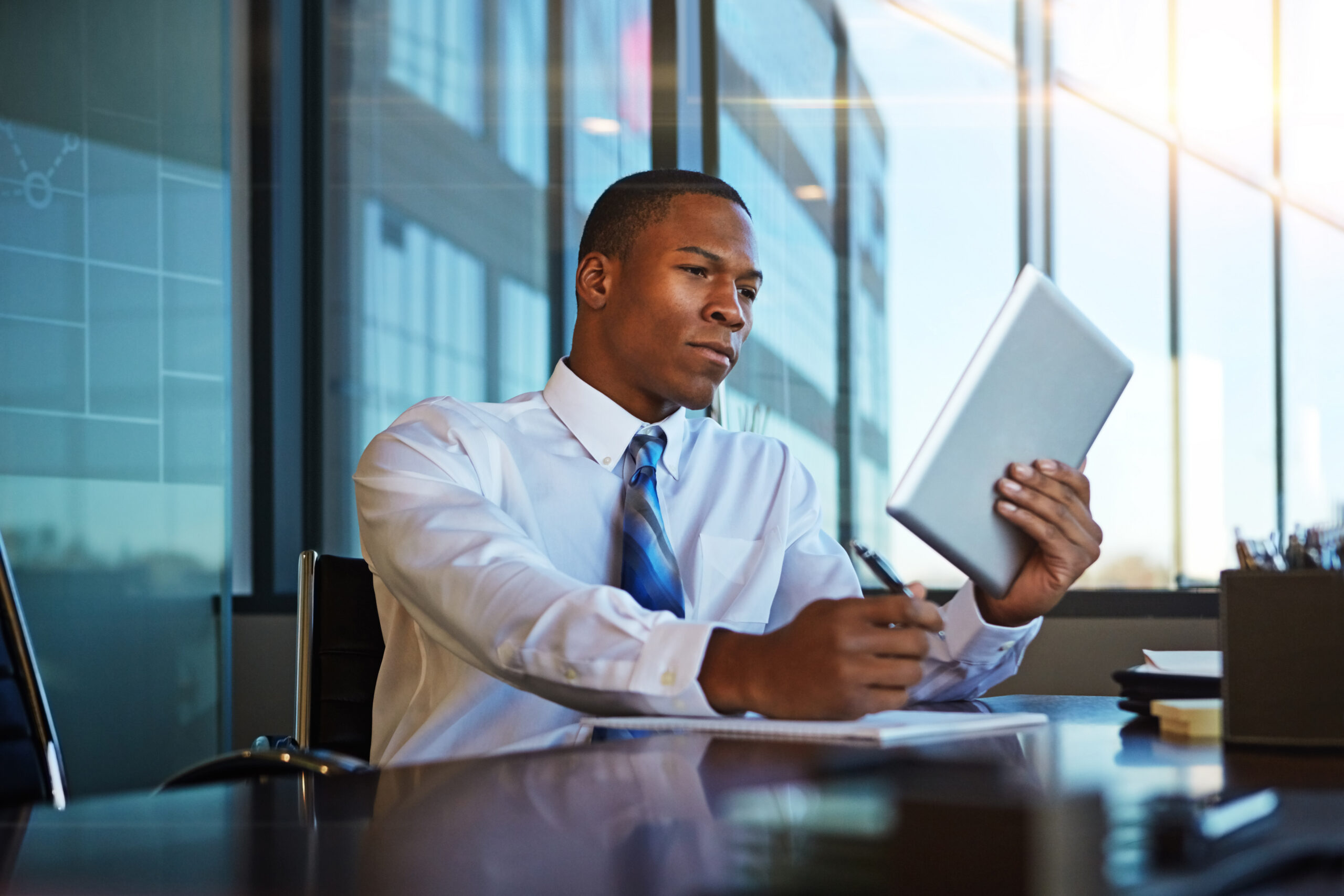 Privacy Counsel reviewing digital information and notes on a tablet