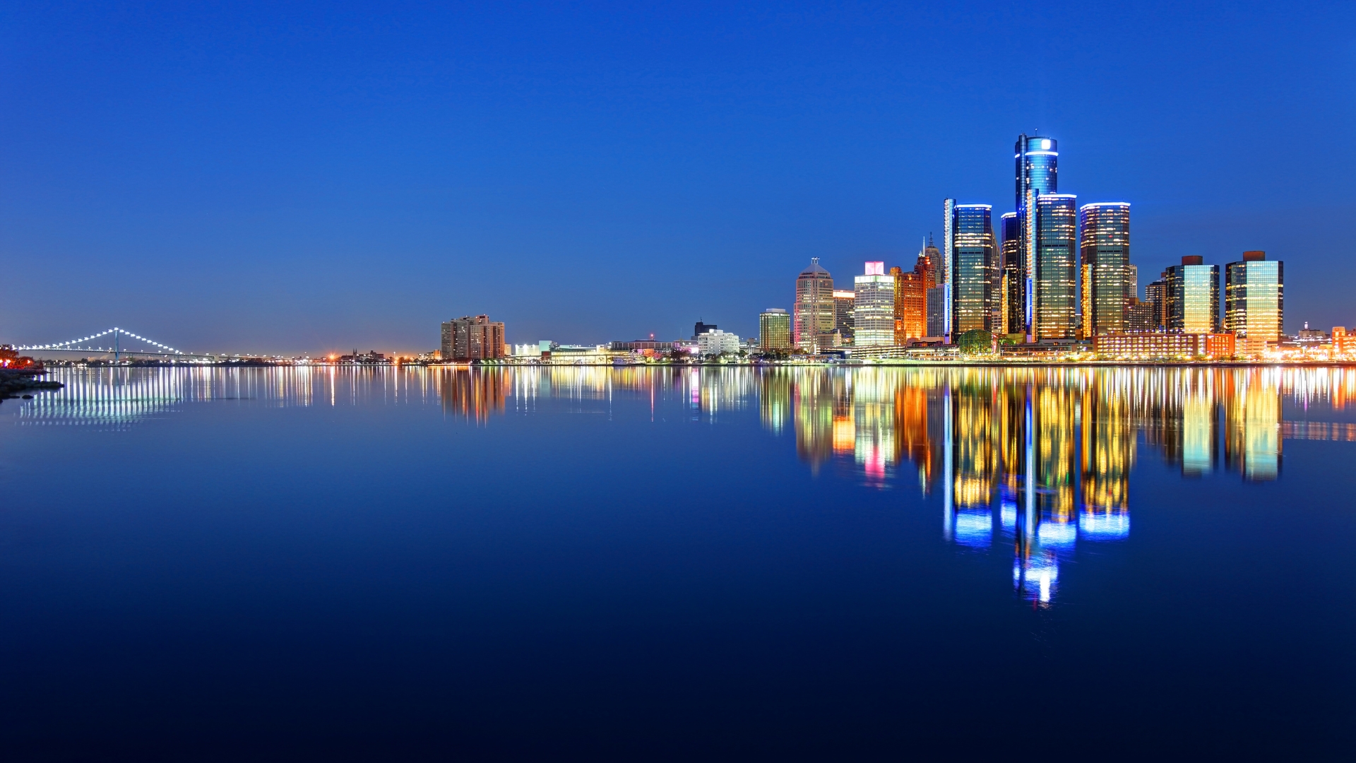 Downtown Detroit skyline illuminated along the waterfront at night