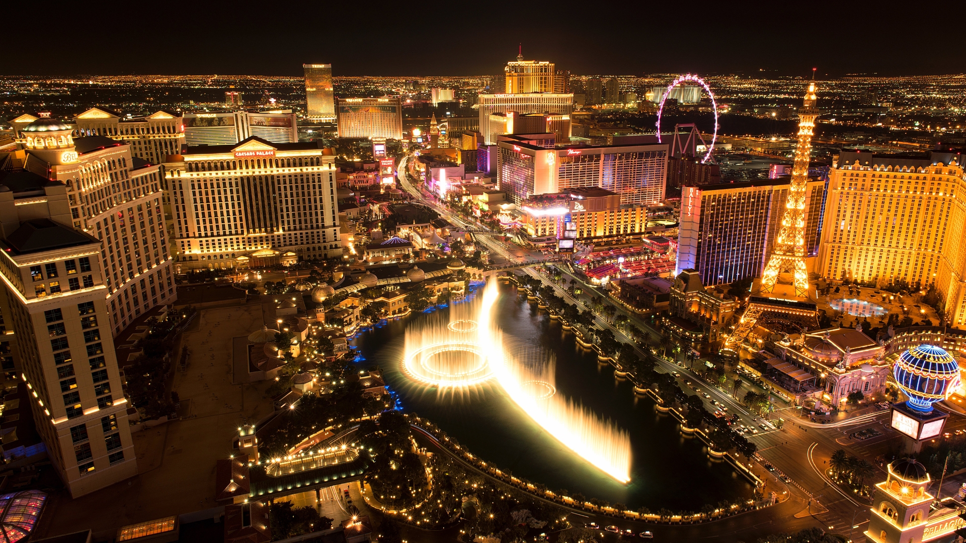 Illuminated hotels and fountains along the Las Vegas Strip at night